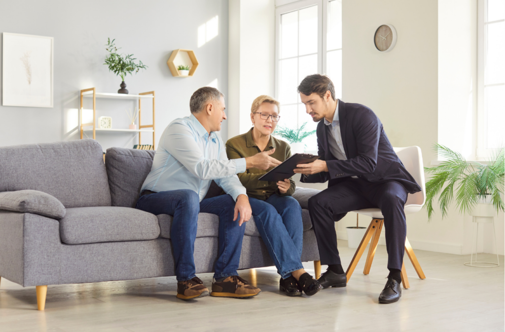 Senior Couple Negotiating With Financial Consultant Or Insurance Agent
