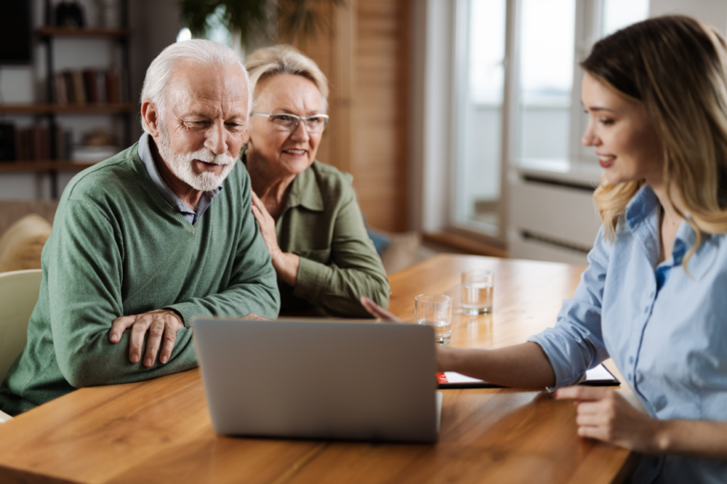 Senior couple talking to insurance agent at home